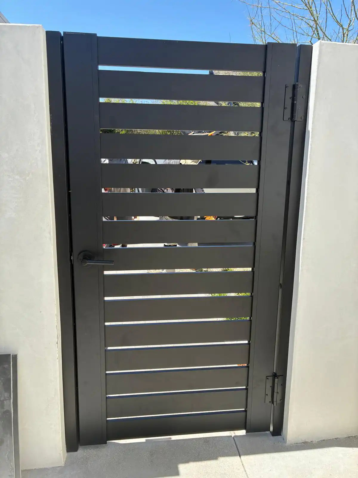 Installed pedestrian gate built with black ALU 40 aluminum slats