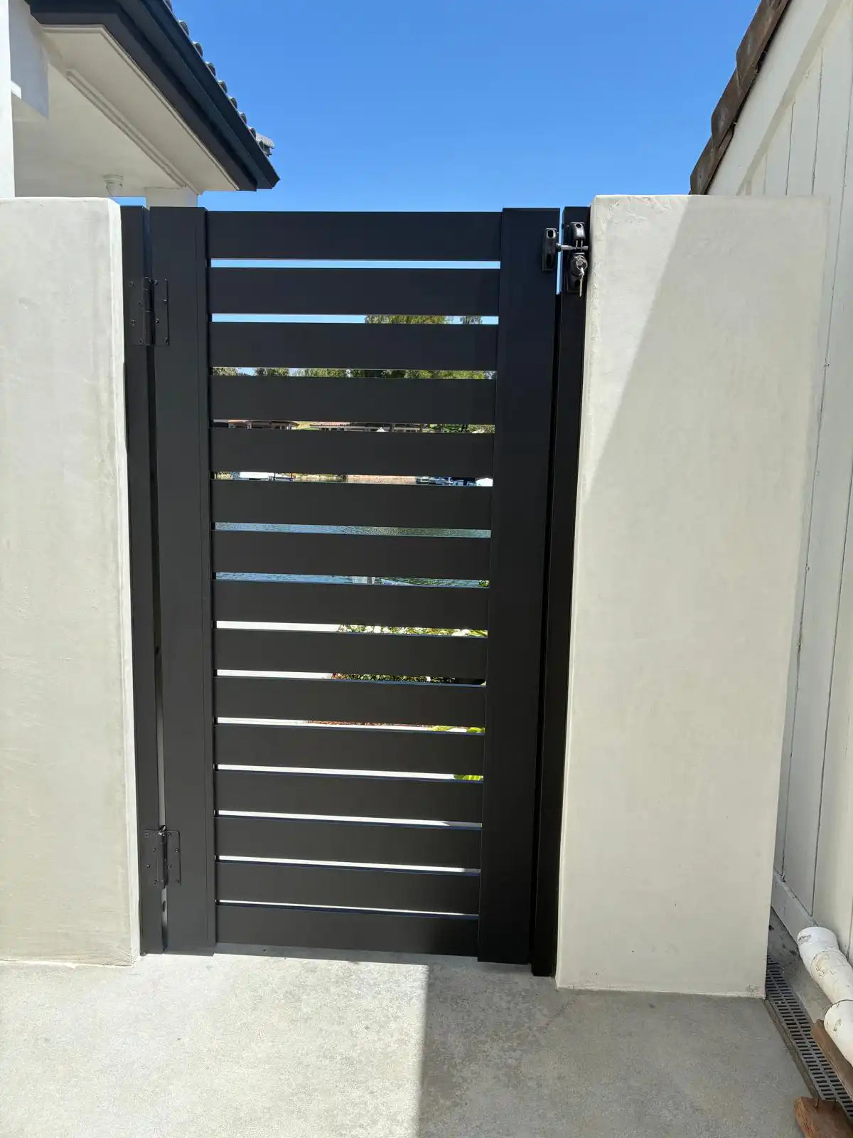Black ALU 40 horizontal aluminum slats on an installed pedestrian gate