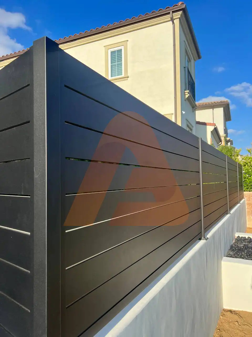 Black ALU 40 horizontal aluminum slat fence installed on a residential property