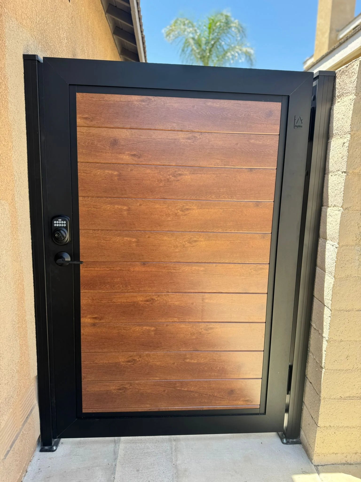 Modern wood-look aluminum gate with black heavy-duty frame