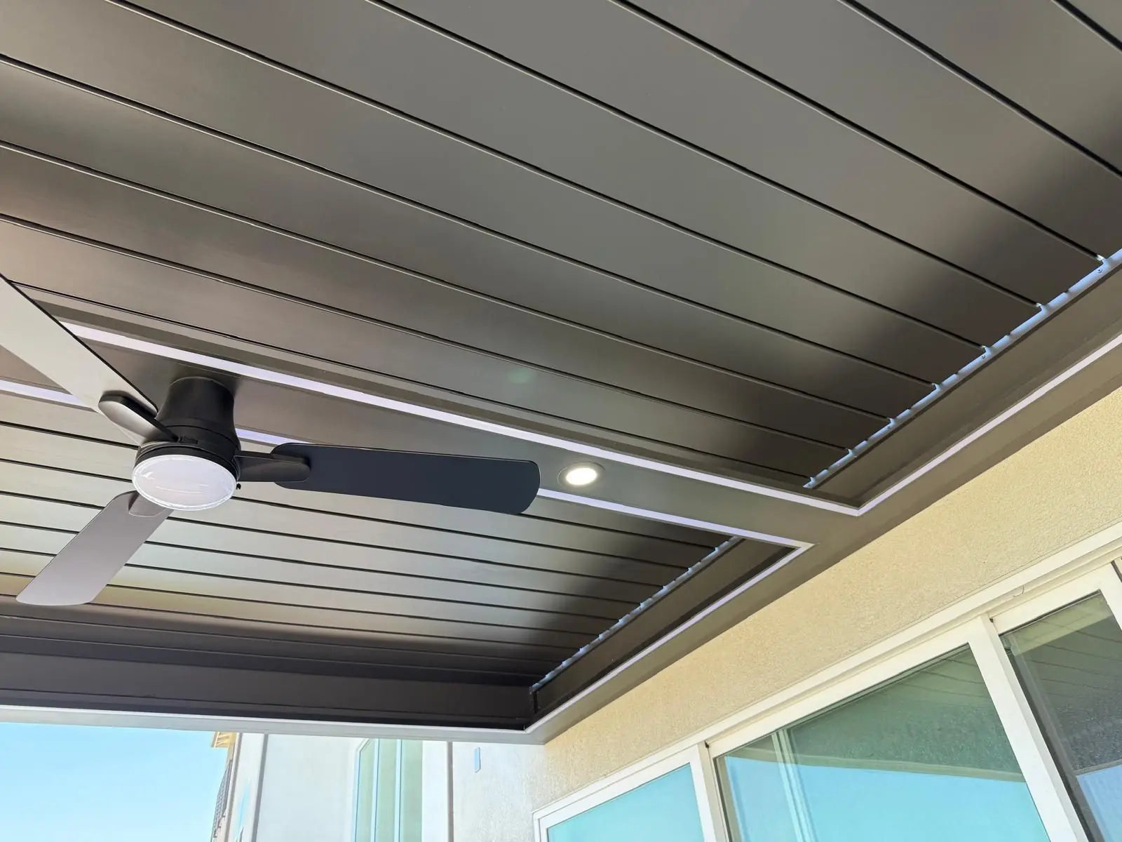 Aluminum louver patio with integrated LED lighting and ceiling fan
