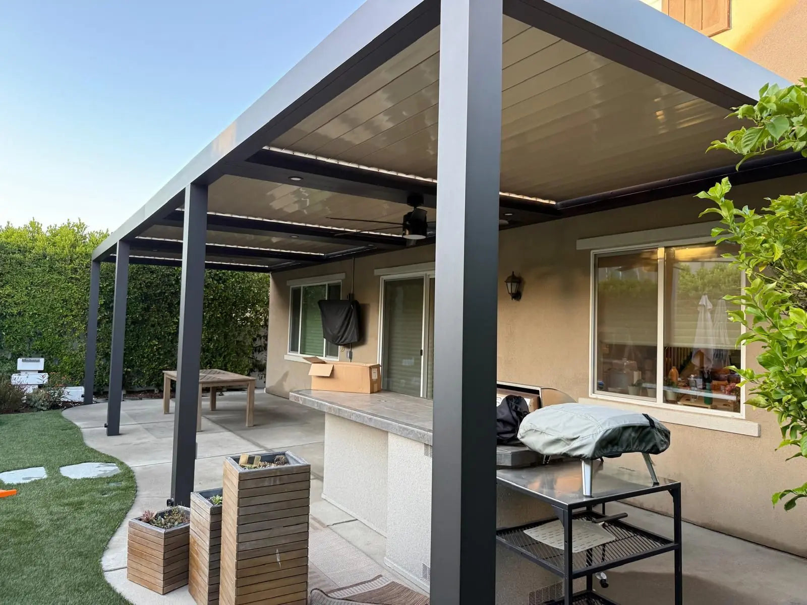 Large-format aluminum louver patio arranged around a custom project layout